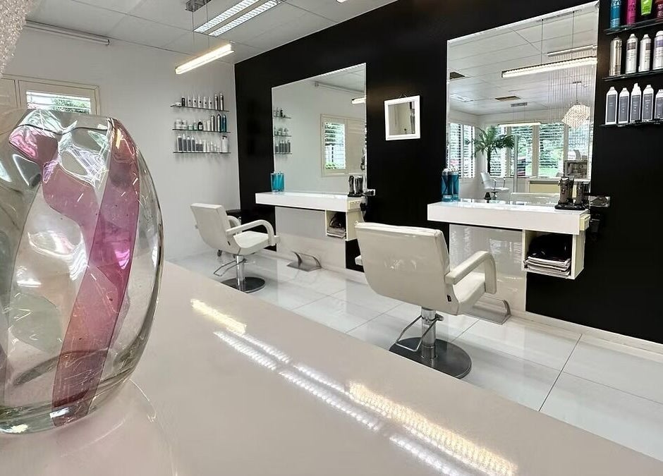Modern interior of The Edge Hill Hairdressers in Edge Hill, Queensland, AU, featuring stylish chairs and decor.