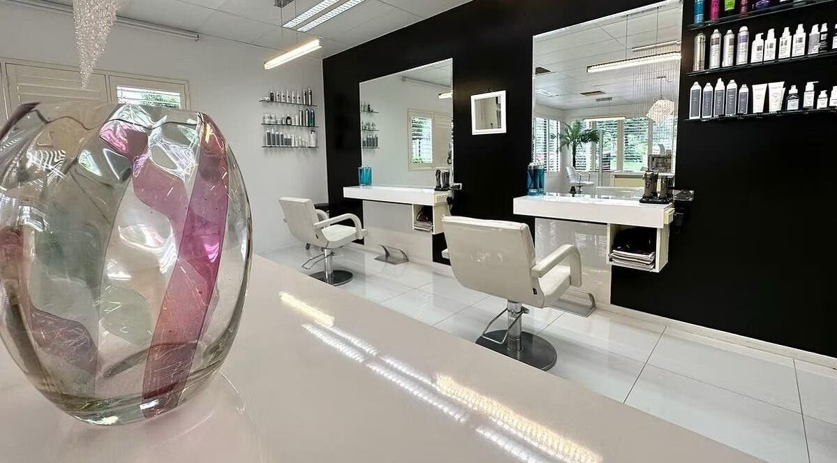 Modern interior of The Edge Hill Hairdressers in Edge Hill, Queensland, AU, featuring stylish chairs and decor.