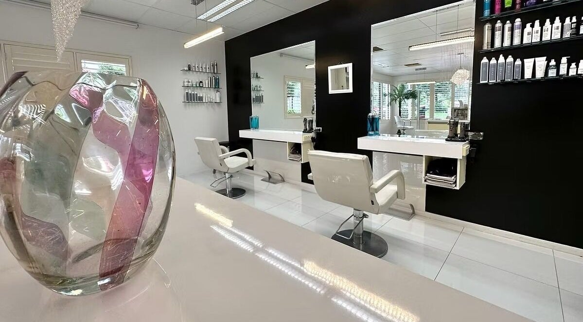 Modern interior of The Edge Hill Hairdressers in Edge Hill, Queensland, AU, featuring stylish chairs and decor.