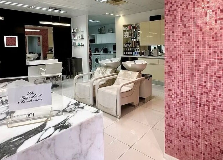 Modern salon interior at The Edge Hill Hairdressers in Edge Hill, Queensland, AU with stylish decor and seating.