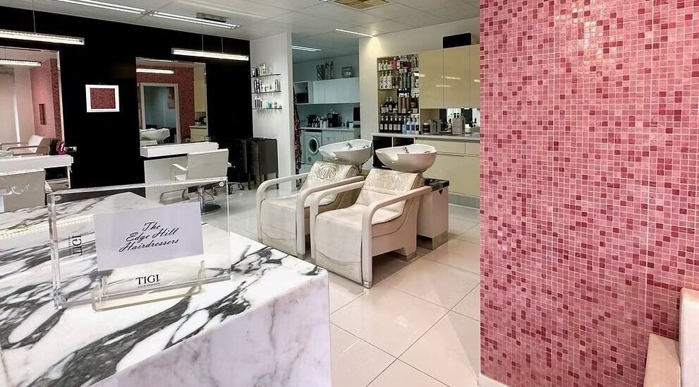 Modern salon interior at The Edge Hill Hairdressers in Edge Hill, Queensland, AU with stylish decor and seating.