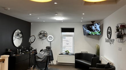 Interior of Leigh the Barber in Barrow in Furness, England, featuring modern decor and styling chairs.