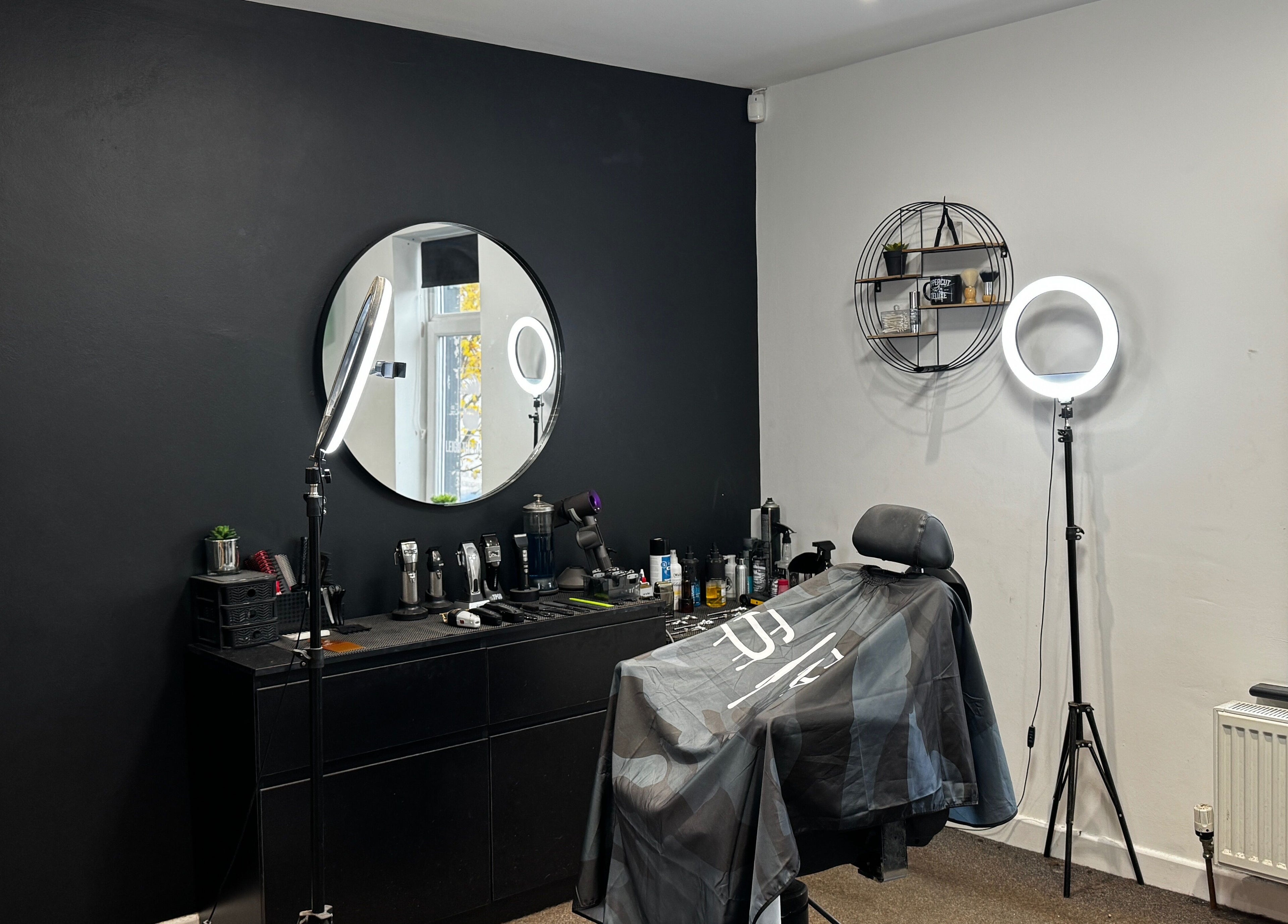 Modern barber setup at Leigh the Barber, Barrow in Furness, England, GB, featuring sleek styling tools and chair.