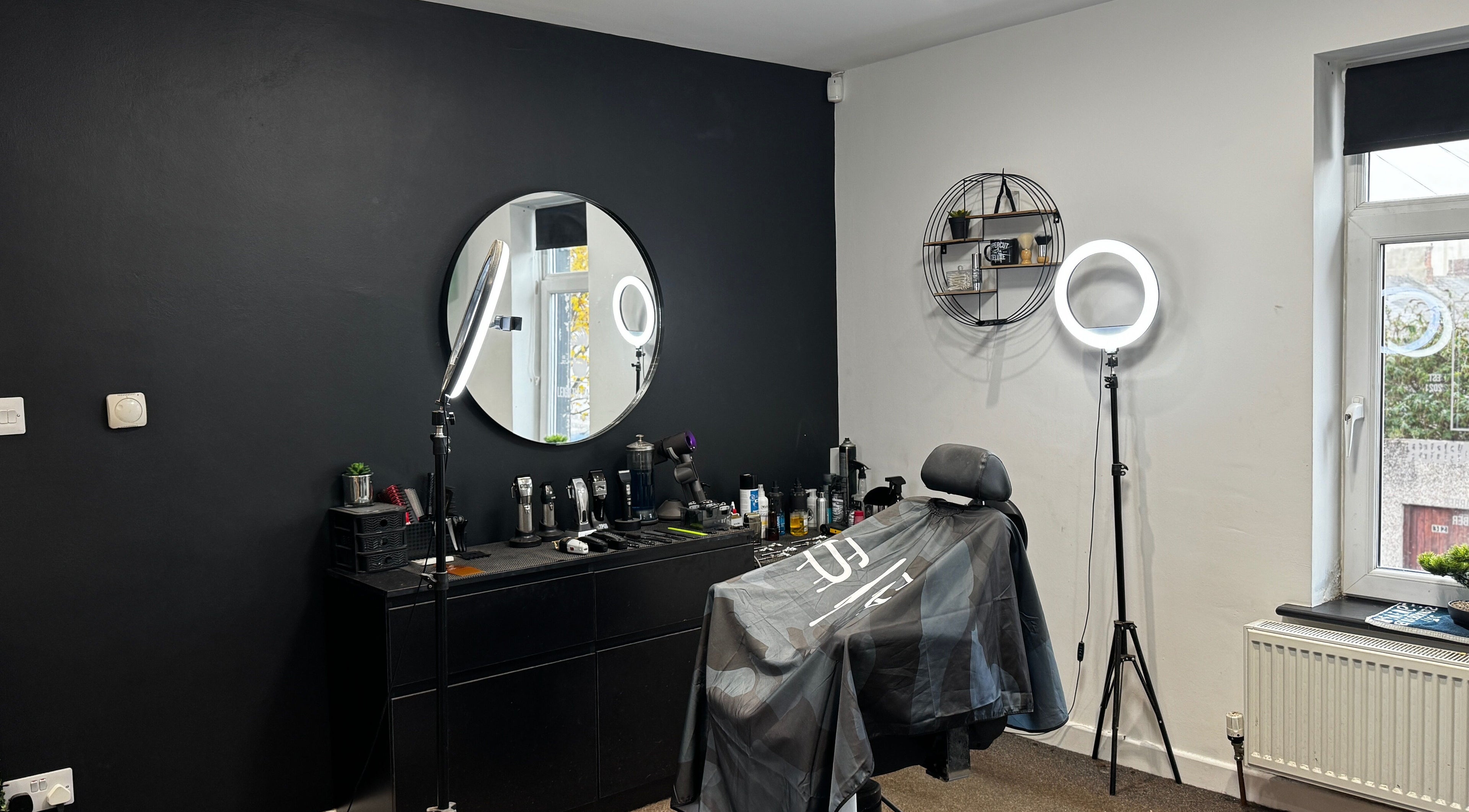 Modern barber setup at Leigh the Barber, Barrow in Furness, England, GB, featuring sleek styling tools and chair.