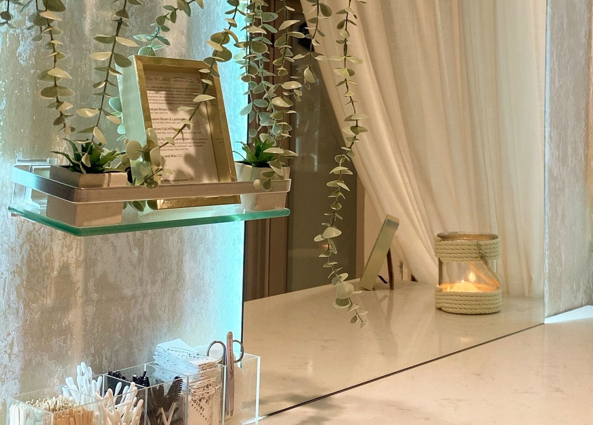 Stephanie Cole SPMU and Advanced Skincare Bingham, England features a serene shelf with greenery and candles.
