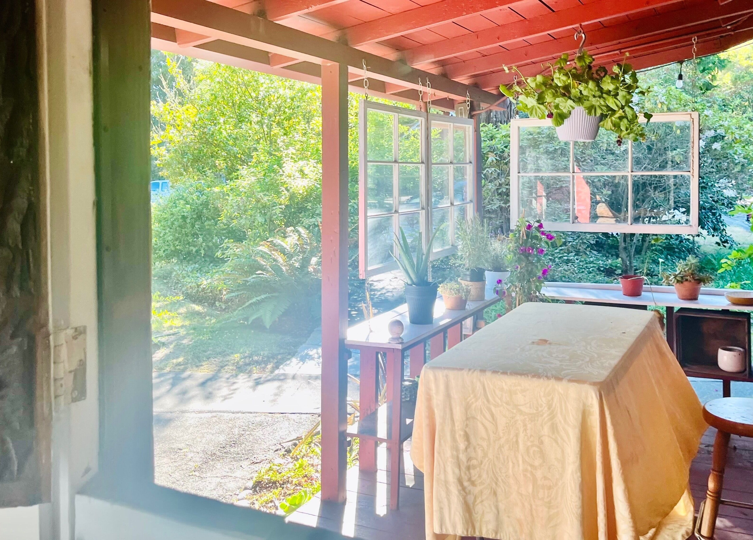 Tranquil outdoor patio at Adorn Apothecary, Aptos, California, US, featuring lush greenery and cozy seating.