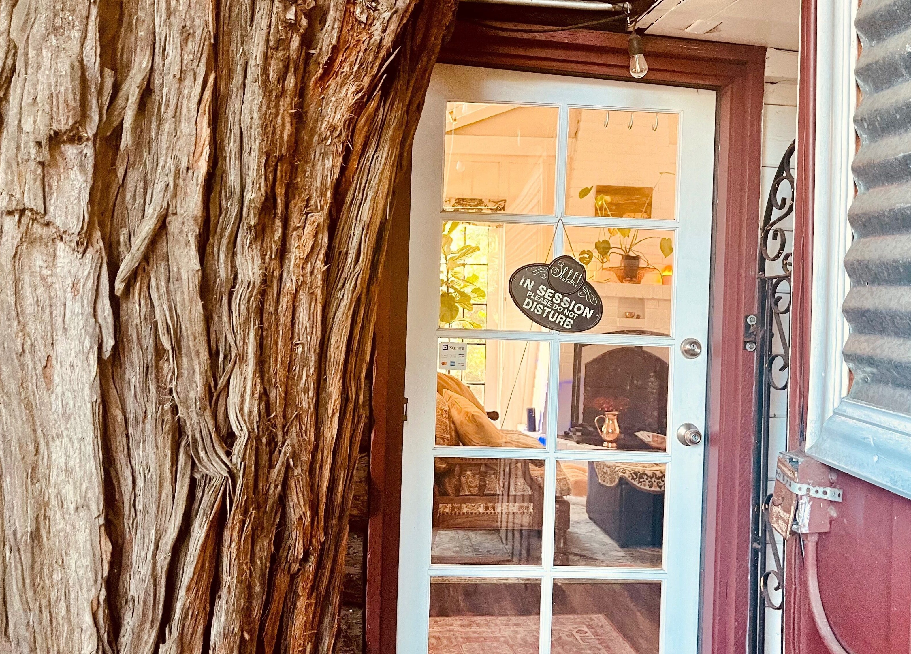 Charming entrance at Adorn Apothecary in Aptos, California, US with a sign 'In Session, Do Not Disturb'.