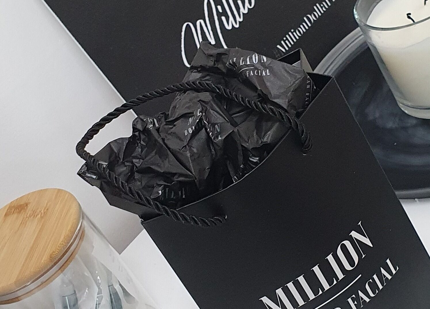 Elegant setup at Skin Revision in Douglas, IM featuring luxury spa products and candle.