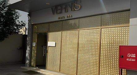 Elegant entrance of Vernis Nail Spa - Al Nakheel Branch, Riyadh, SA featuring a golden facade.