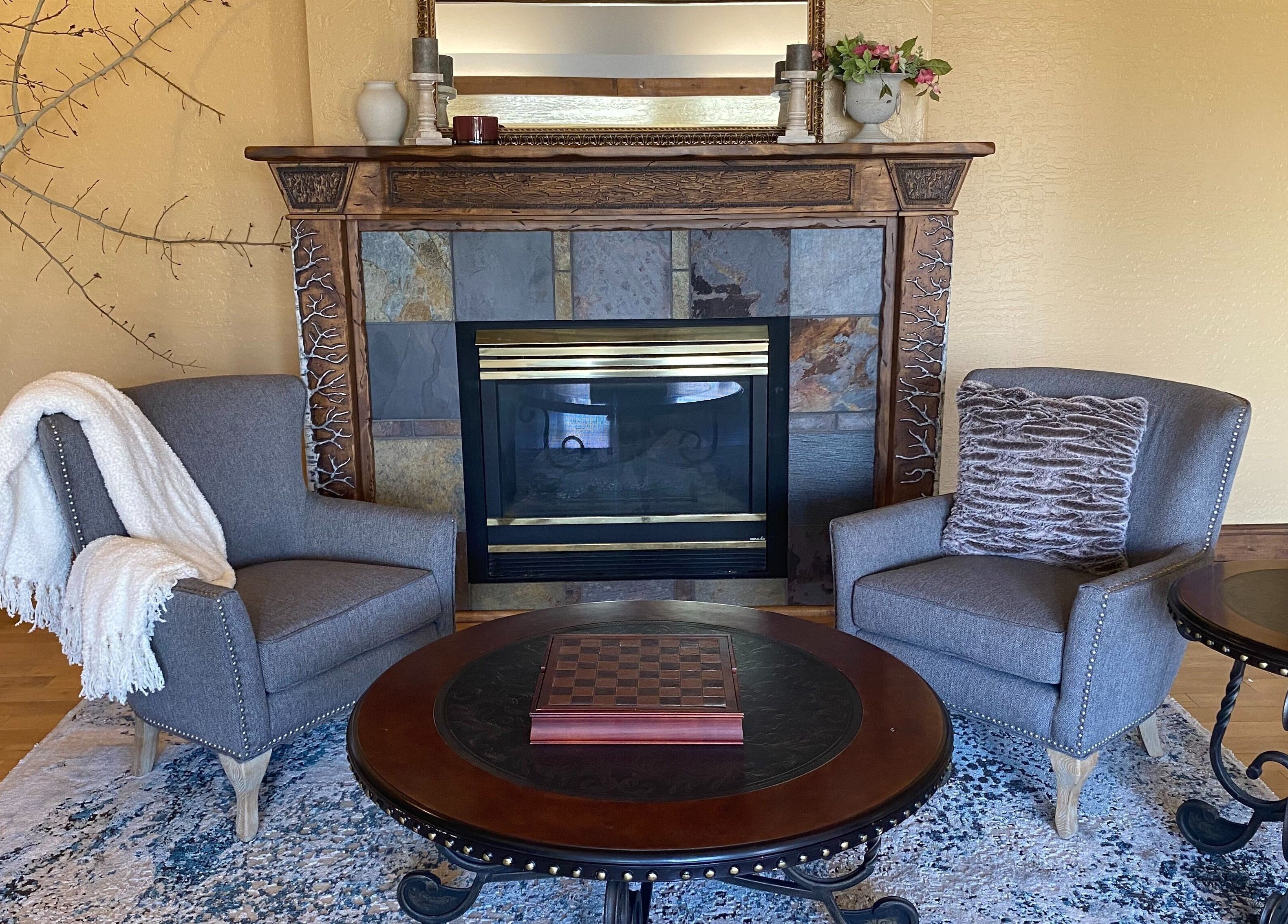 Inviting seating area by the fireplace at Massage Therapy Studio in Great Falls, Montana, US.