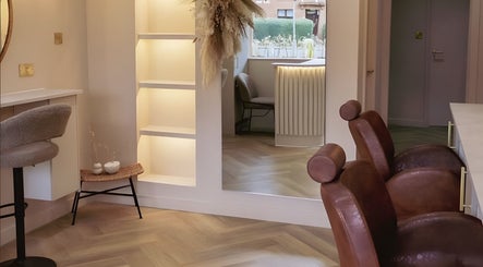 Lux - Clarkston salon interior in Glasgow, Scotland, GB, showcasing stylish chairs and modern decor.