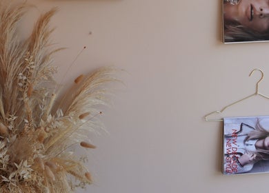 Elegant magazine wall display with dried pampas grass at Lux - Clarkston, Glasgow, Scotland, GB.