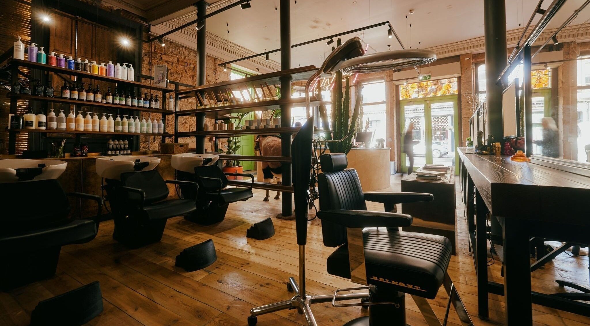 Interior of At 66 Hair and Lifestyle - Finnieston in Glasgow, Scotland, GB with stylish chairs and shelves.