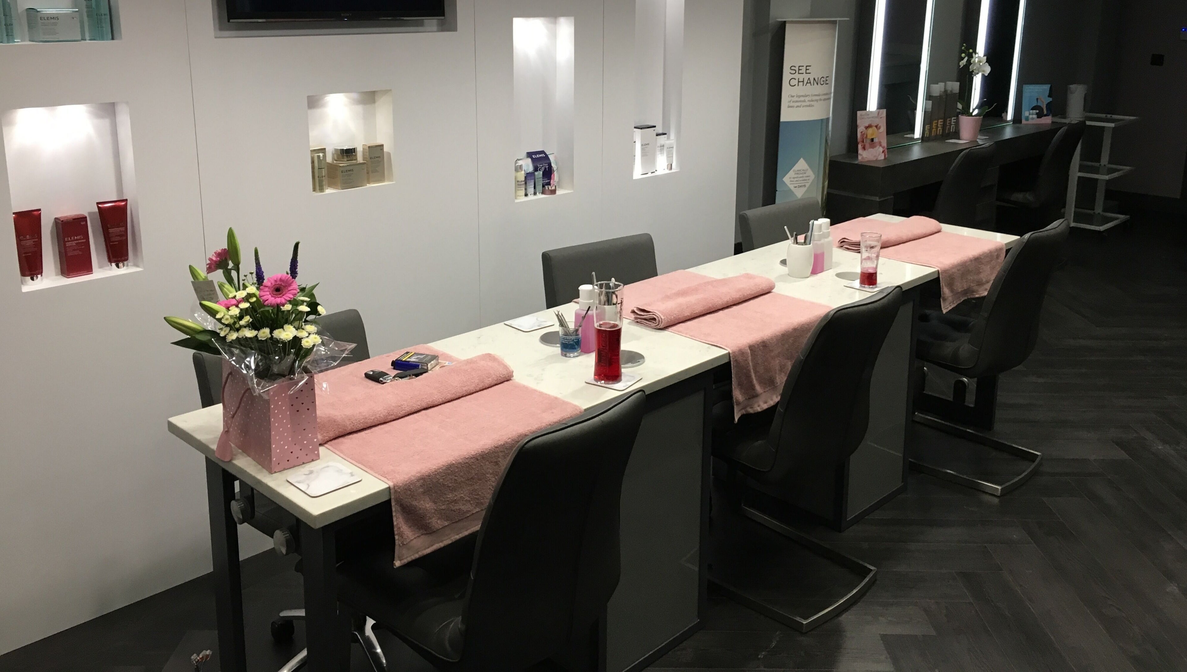 Manicure stations with pink towels and flowers at Chula, Sheffield, England, GB.