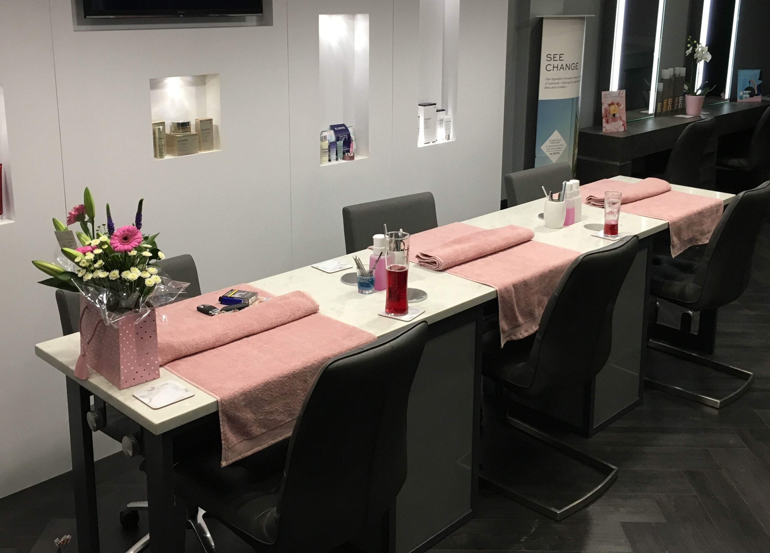 Manicure stations with pink towels and flowers at Chula, Sheffield, England, GB.