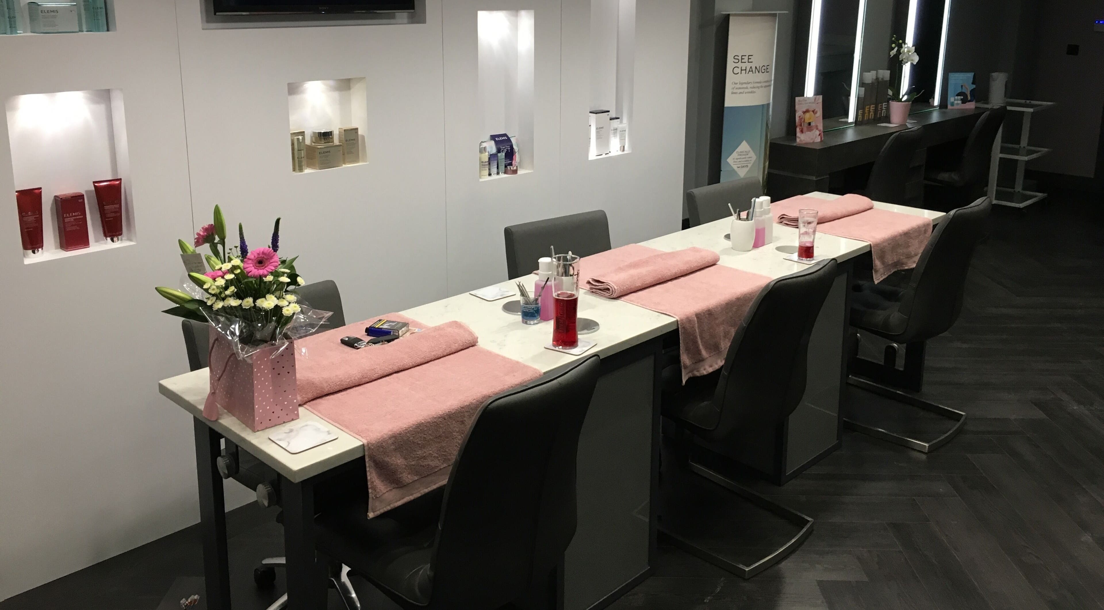 Manicure stations with pink towels and flowers at Chula, Sheffield, England, GB.