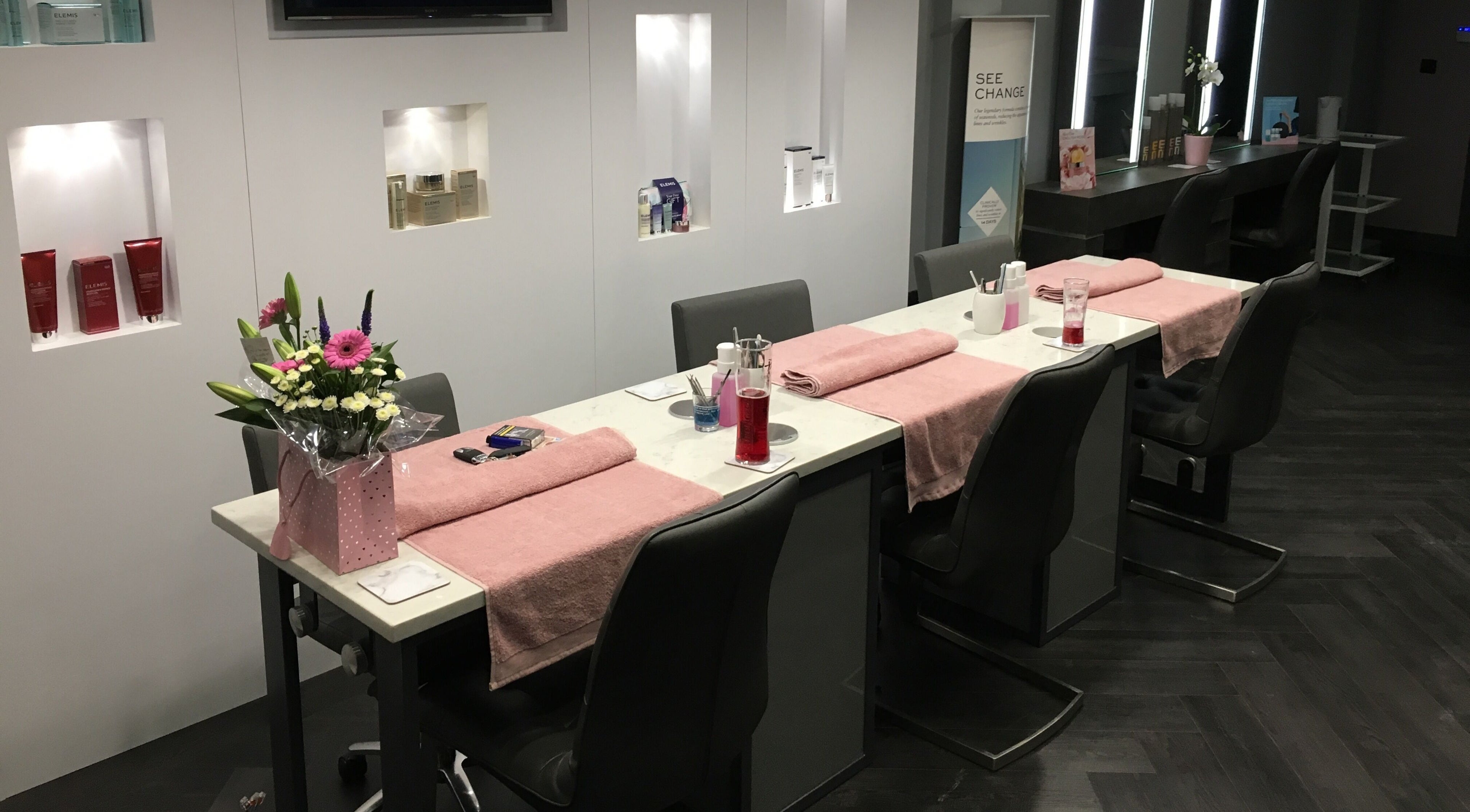 Manicure stations with pink towels and flowers at Chula, Sheffield, England, GB.