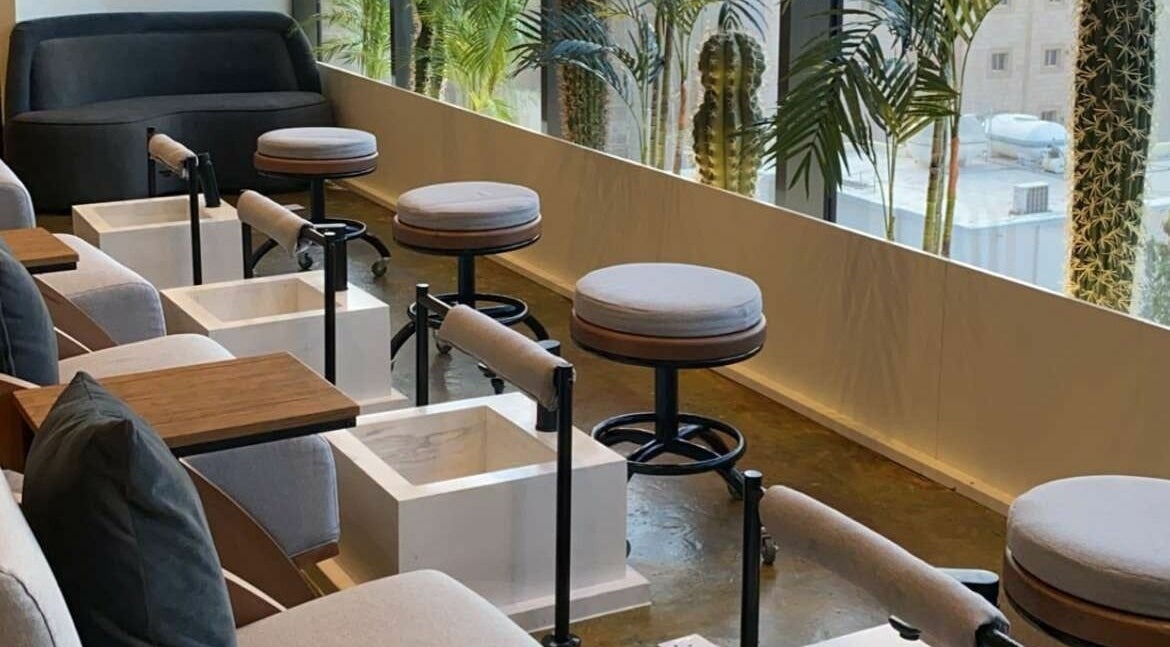 Comfortable pedicure seating at Base Coat Nail Spa in Jeddah, Makkah Province, SA with lush greenery.