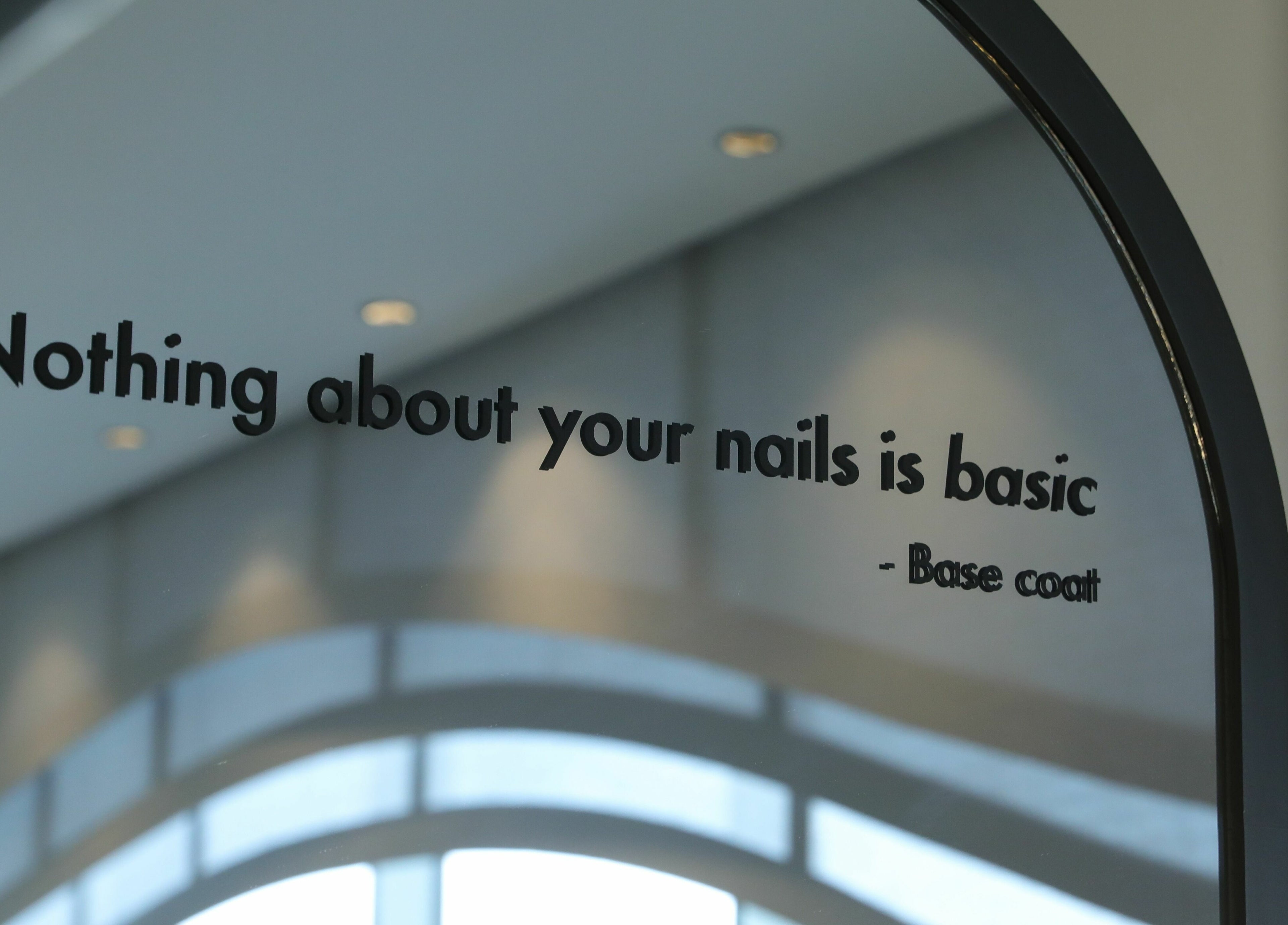 Quote on mirror at Base Coat Nail Spa, Jeddah, Makkah Province, SA, saying 'Nothing about your nails is basic.'