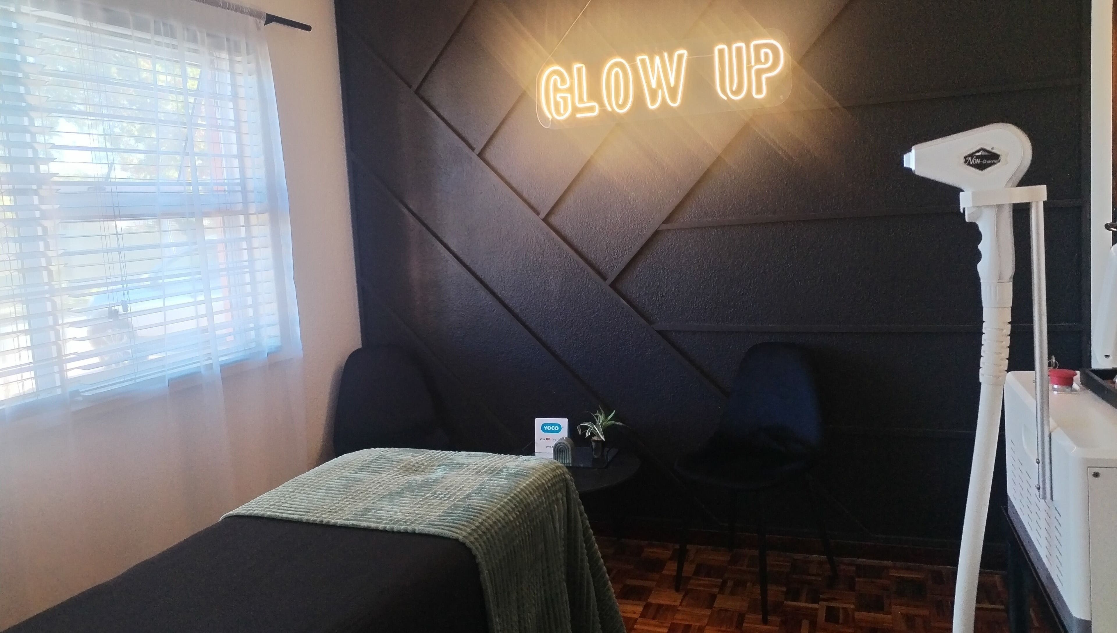 Elegant treatment room at Bare & Blink, Cape Town, Western Cape, ZA with 'Glow Up' sign and modern decor.