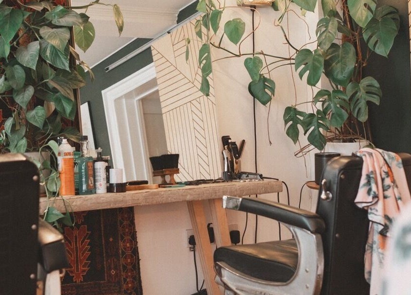 Chic salon chair and mirror at Courage Noble | King Street, Norfolk, England, GB with lush plants.
