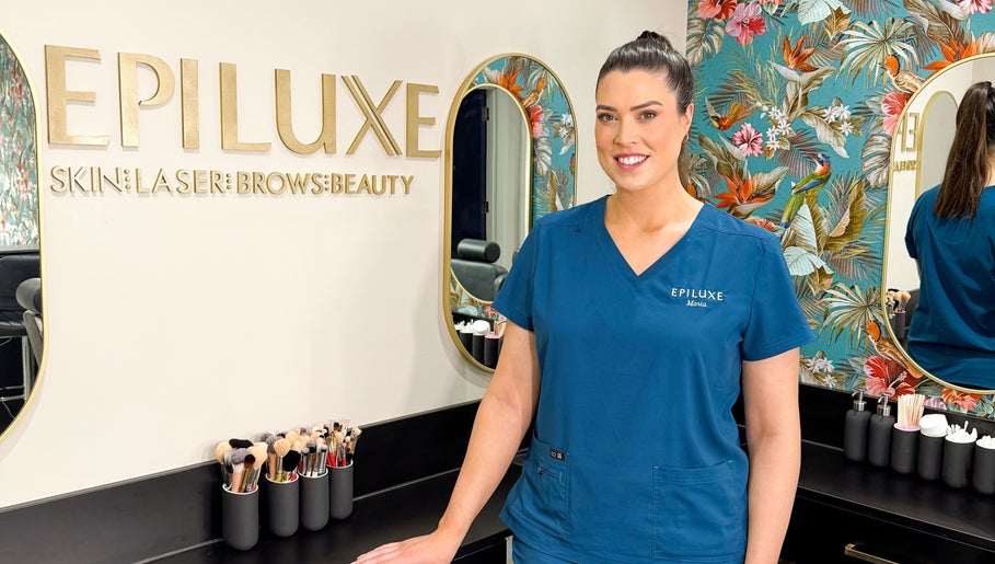Beauty professional at Epiluxe Clinic in Castlerea, Co. Roscommon, IE, with floral decor and beauty tools.