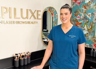 Beauty professional at Epiluxe Clinic in Castlerea, Co. Roscommon, IE, with floral decor and beauty tools.