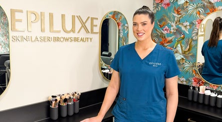 Beauty professional at Epiluxe Clinic in Castlerea, Co. Roscommon, IE, with floral decor and beauty tools.