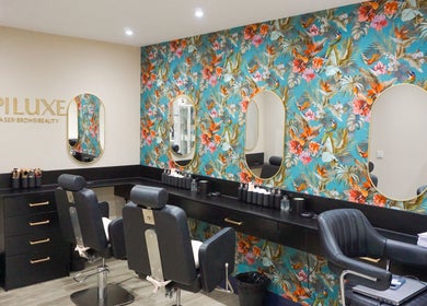 Epiluxe Clinic in Castlerea, Co. Roscommon, IE featuring a vibrant floral wall and modern beauty chairs.