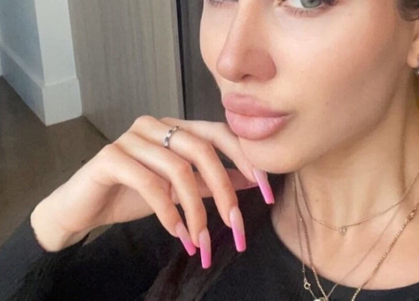 Close-up of a woman with pink nails at Skinsation LA | Skin Tightening, Botox and Lip Fillers by Skinsation LA, Los Angeles, California, US.