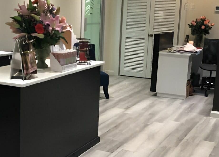 Lobby of Milaya Salon & Medical Spa in Port of Spain with elegant decor and flowers.