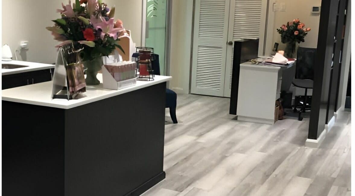 Lobby of Milaya Salon & Medical Spa in Port of Spain with elegant decor and flowers.