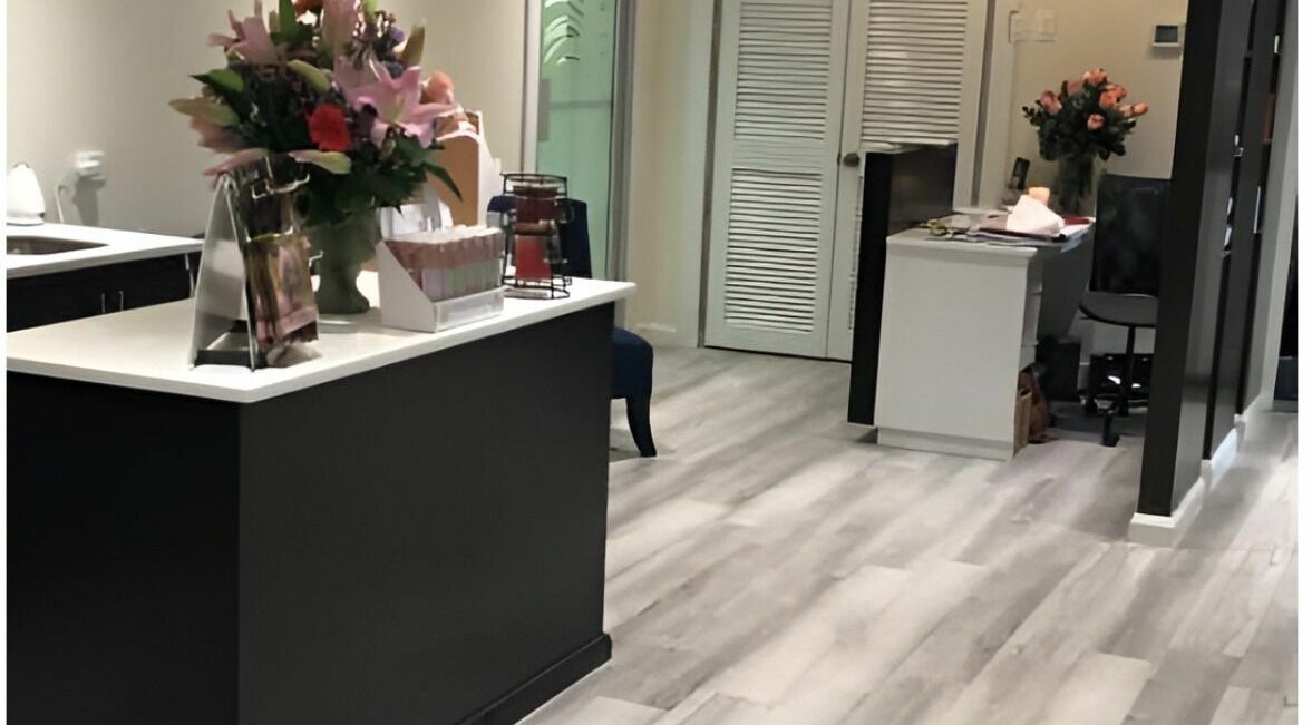 Lobby of Milaya Salon & Medical Spa in Port of Spain with elegant decor and flowers.