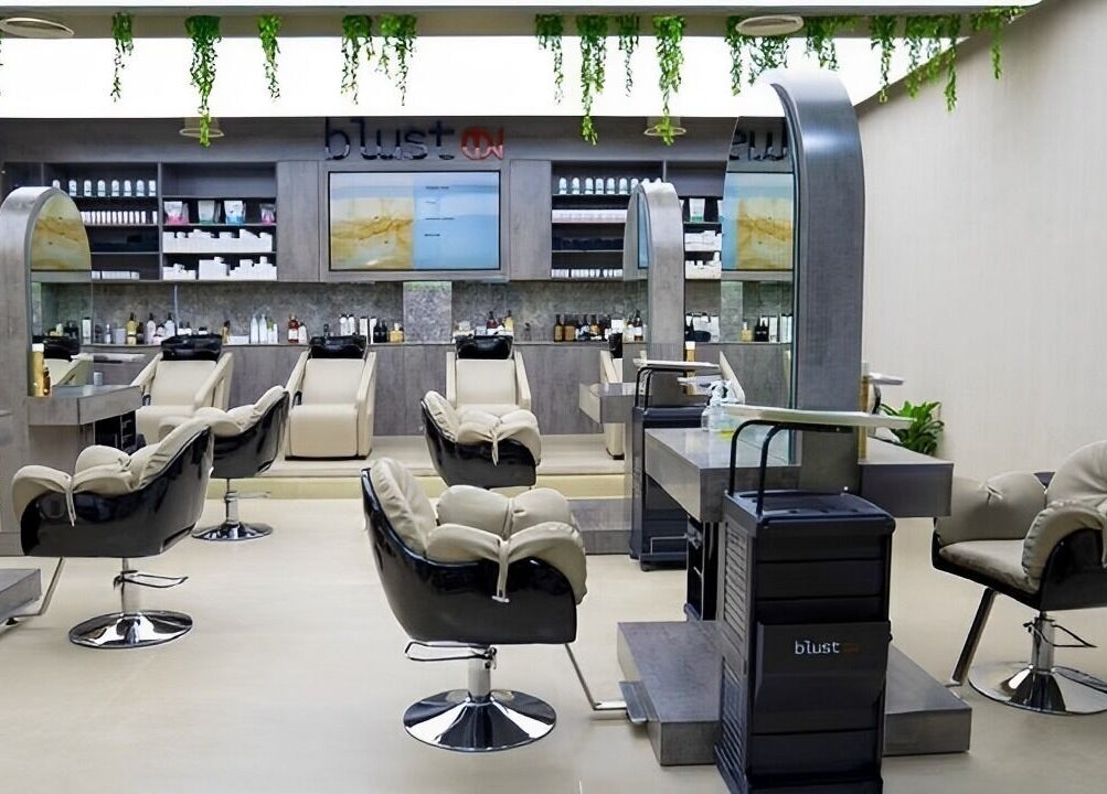 Elegant salon interior at Victor Keyrouz X Amaraya, featuring plush chairs and sleek mirrors in Dubai, AE.