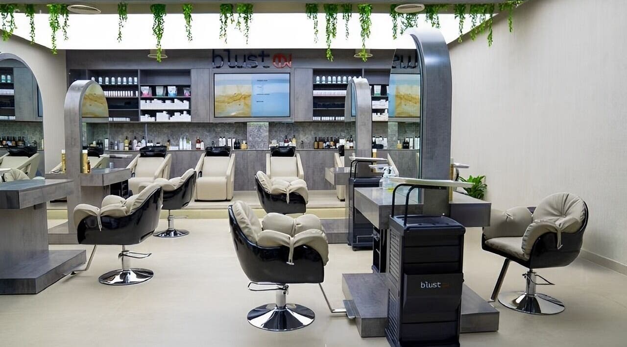 Elegant salon interior at Victor Keyrouz X Amaraya, featuring plush chairs and sleek mirrors in Dubai, AE.