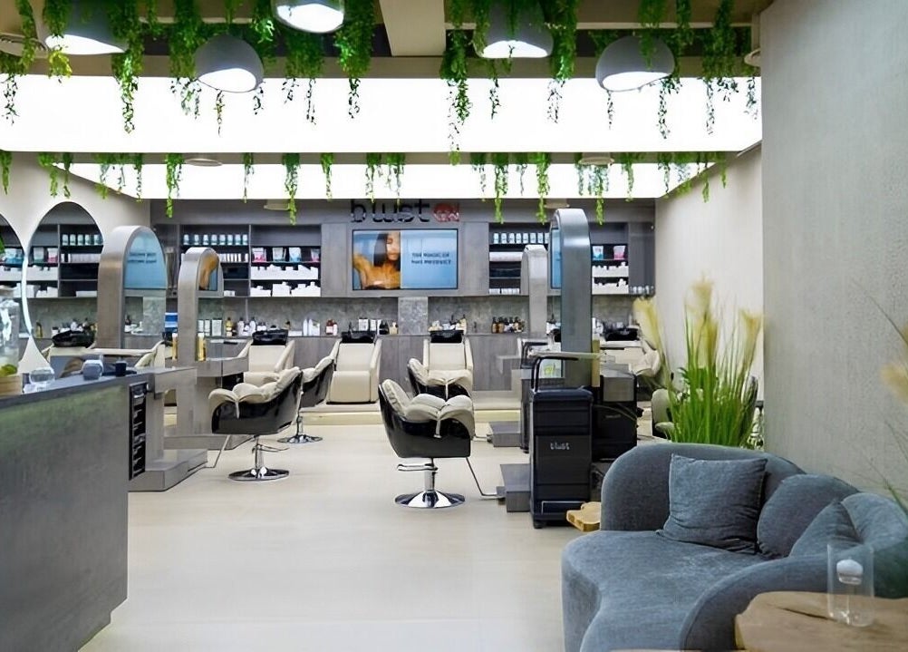 Chic salon interior at Victor Keyrouz X Amaraya, Dubai, AE with stylish chairs and greenery accents.