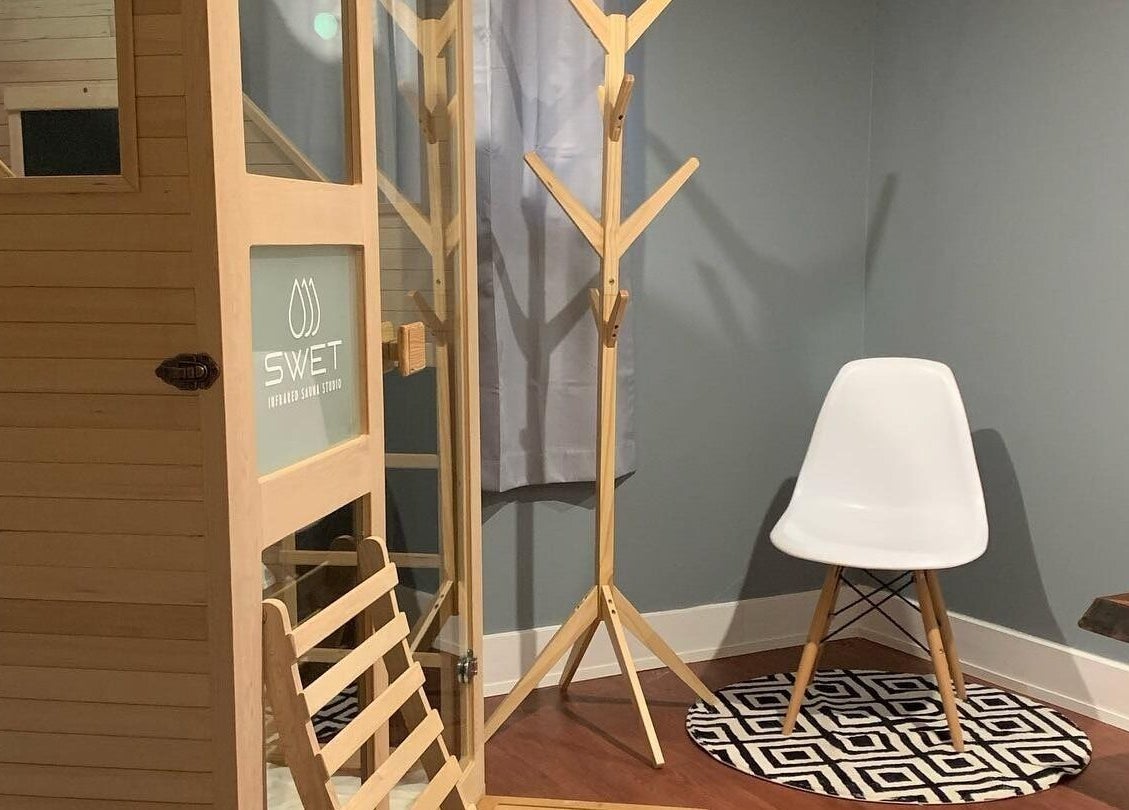 Cozy interior at SWET Infrared Sauna Studio - Forest Hills, Grand Rapids, Michigan, US with chair and wooden sauna.