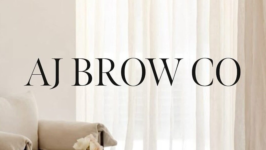 AJ Brow Co logo with elegant decor at Aberdeen, Scotland, GB. Chic white curtain backdrop.