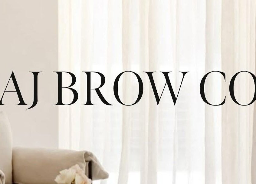 AJ Brow Co logo with elegant decor at Aberdeen, Scotland, GB. Chic white curtain backdrop.