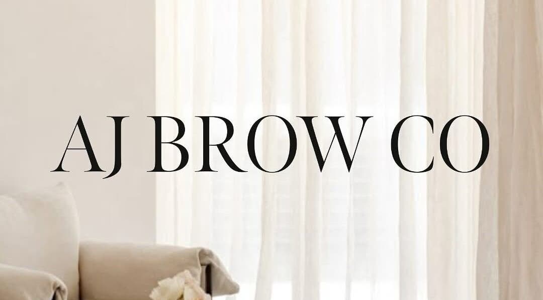 AJ Brow Co logo with elegant decor at Aberdeen, Scotland, GB. Chic white curtain backdrop.