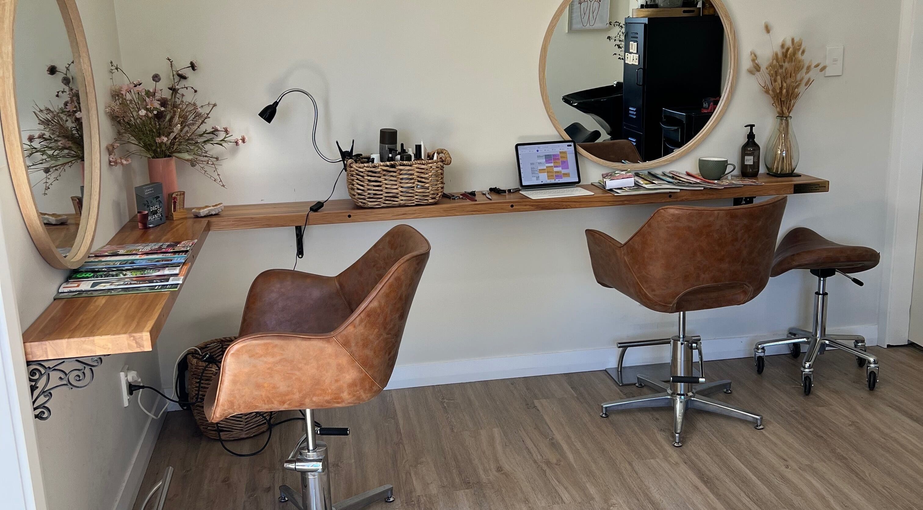 Modern hairdressing station at I'm Hair Hairdressing, Masterton, Wairarapa, NZ featuring stylish chairs and mirrors.