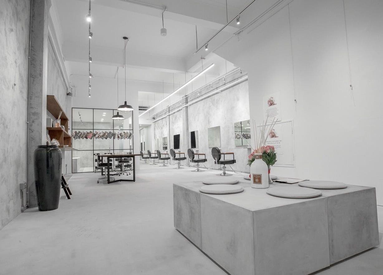 Chic salon interior at The Fluxus House, Singapore, SG, featuring modern decor and styling stations.
