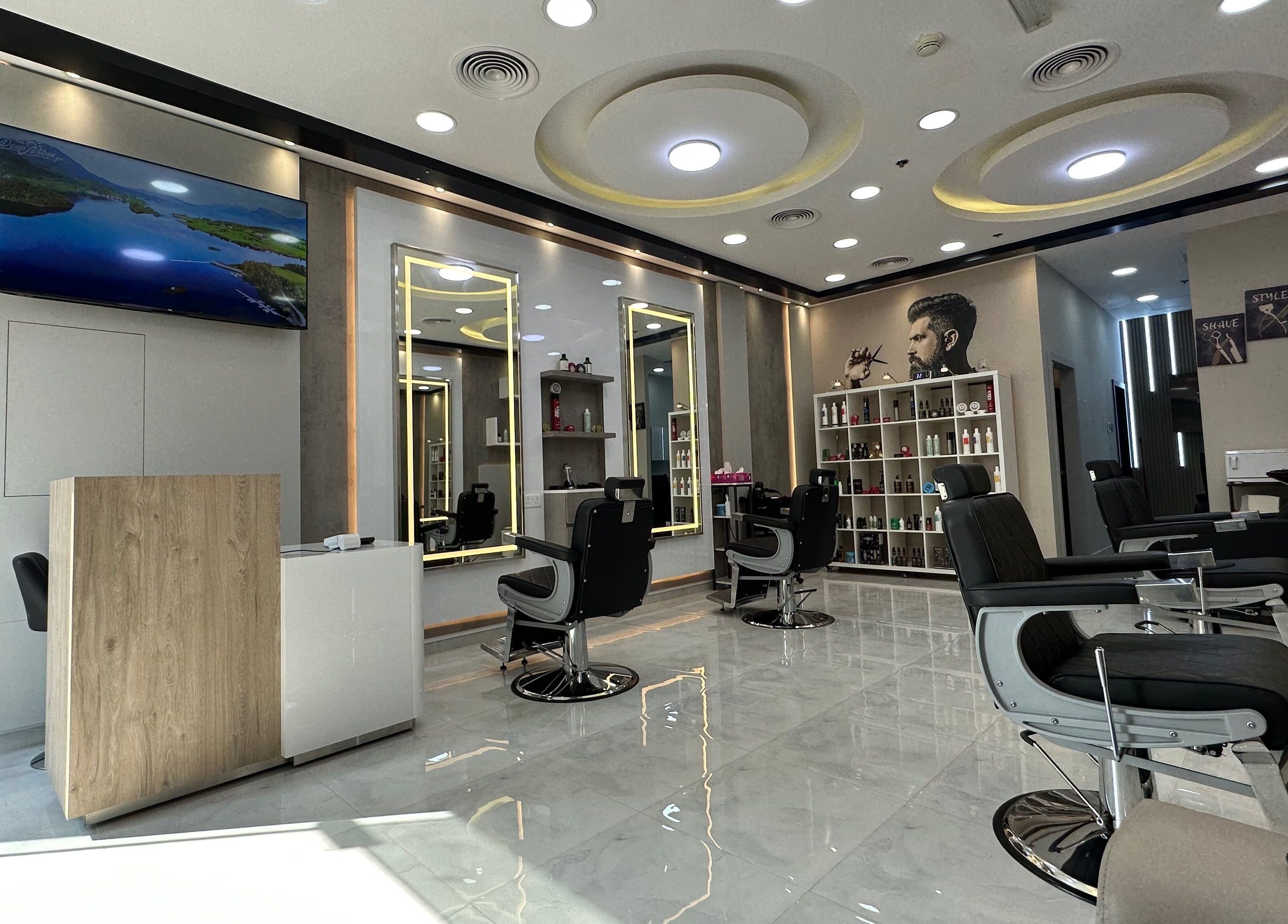 Modern interior of Aleph Gents Salon DMCC in Dubai, AE, with sleek barber chairs and vibrant lighting.