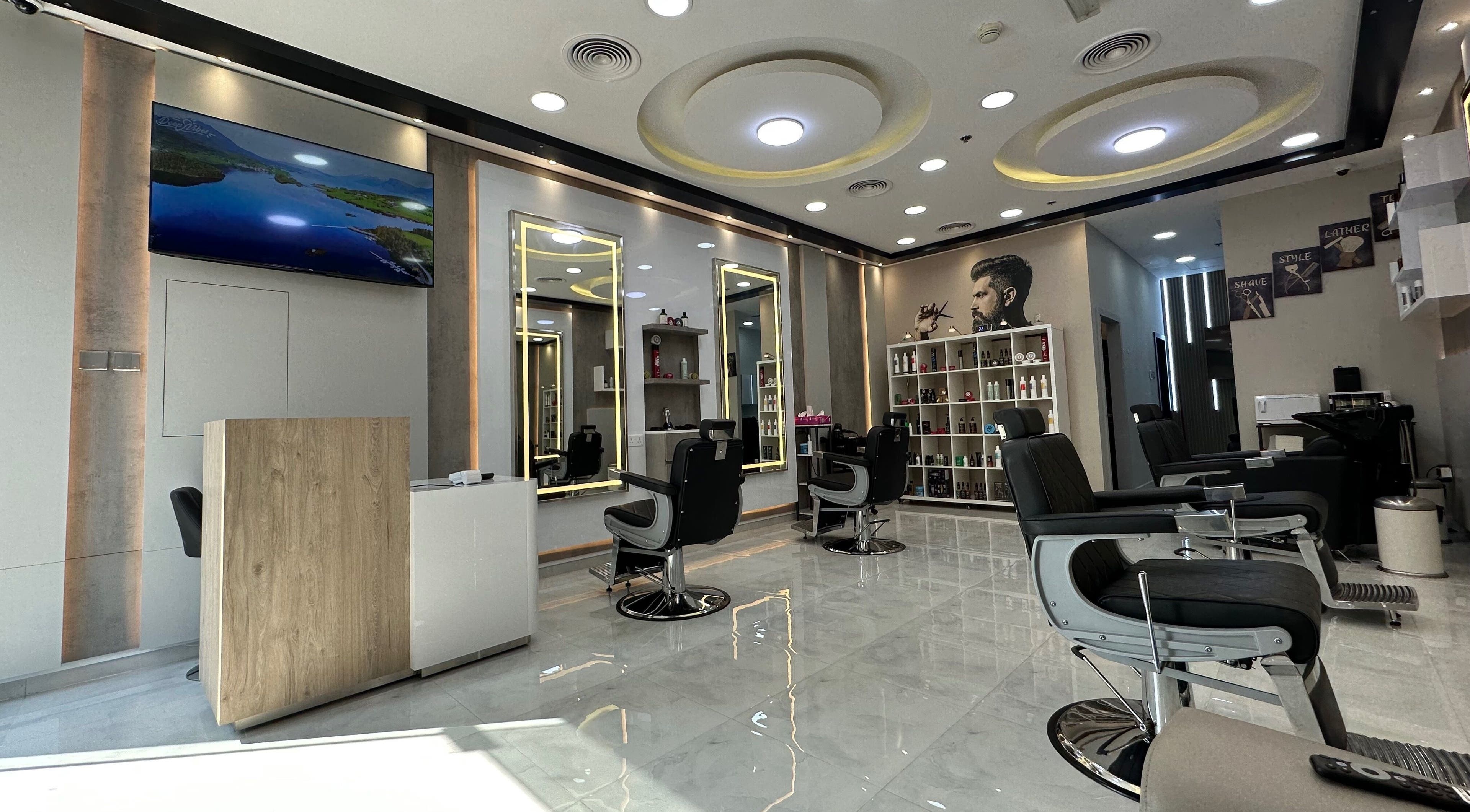 Modern interior of Aleph Gents Salon DMCC in Dubai, AE, with sleek barber chairs and vibrant lighting.