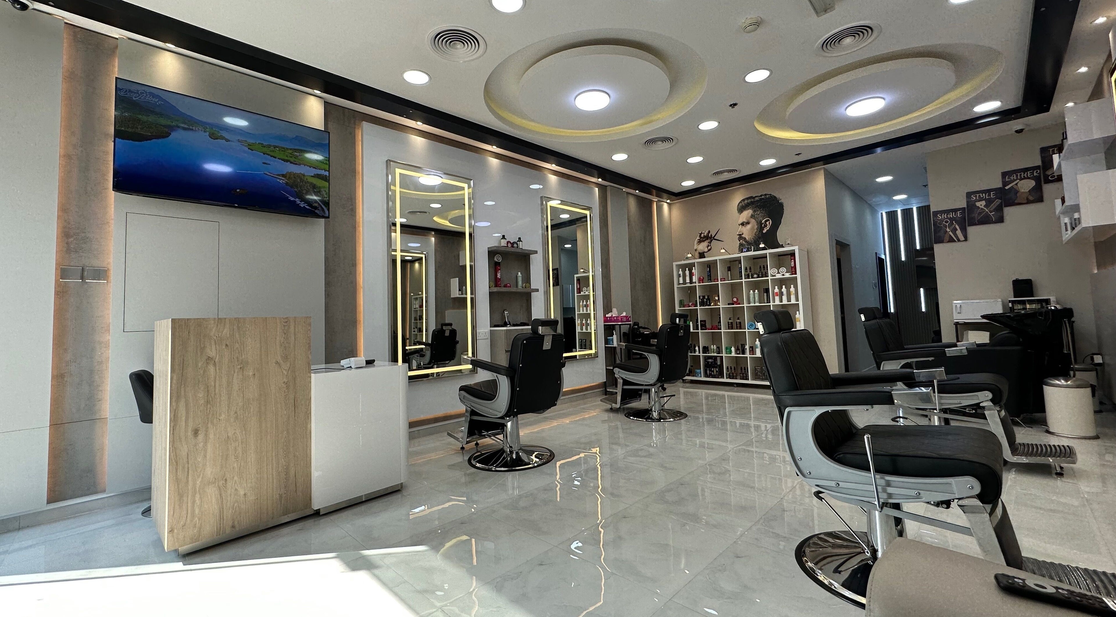 Modern interior of Aleph Gents Salon DMCC in Dubai, AE, with sleek barber chairs and vibrant lighting.