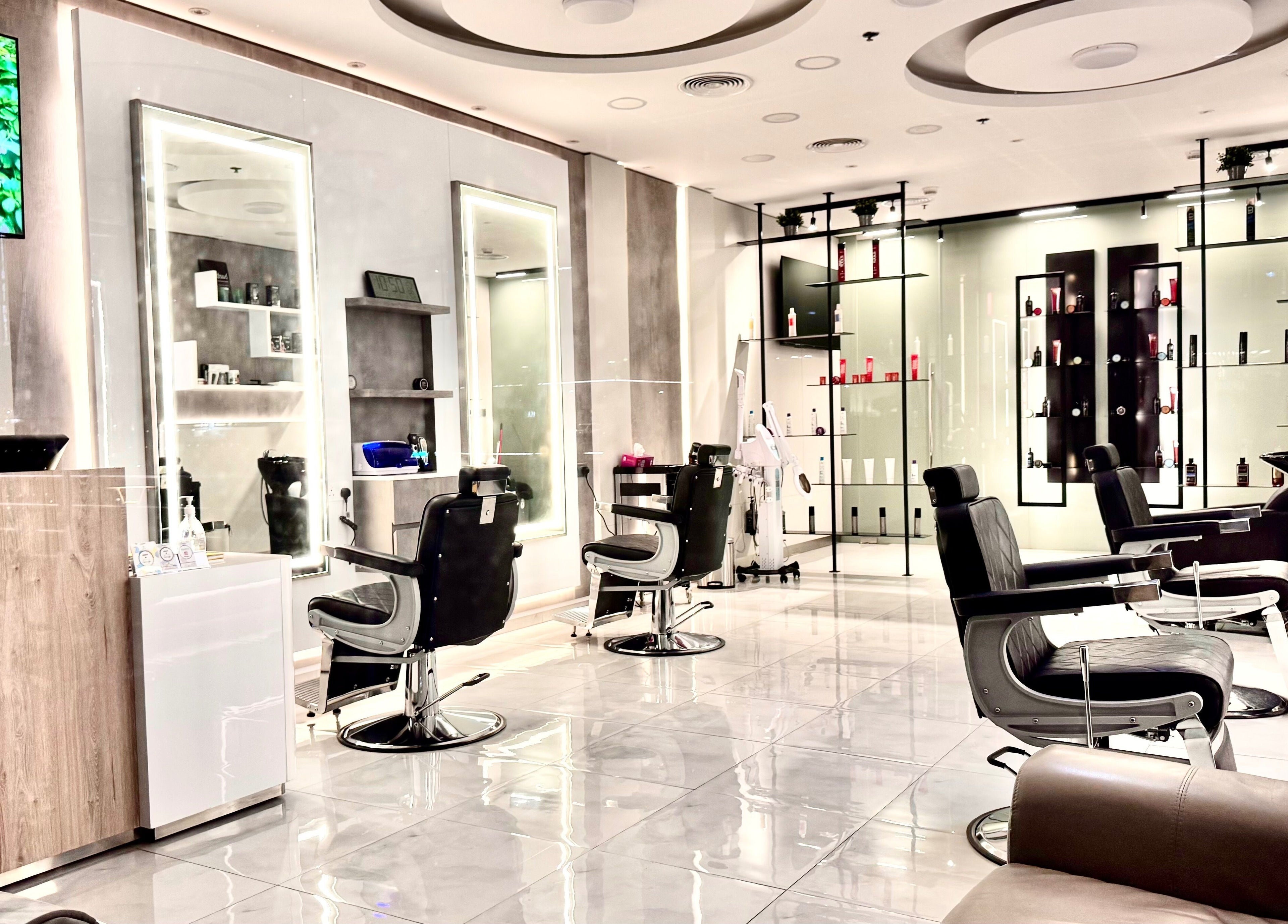 Chic interior of Aleph Gents Salon DMCC in Dubai, AE showcasing stylish barber chairs and sleek decor.