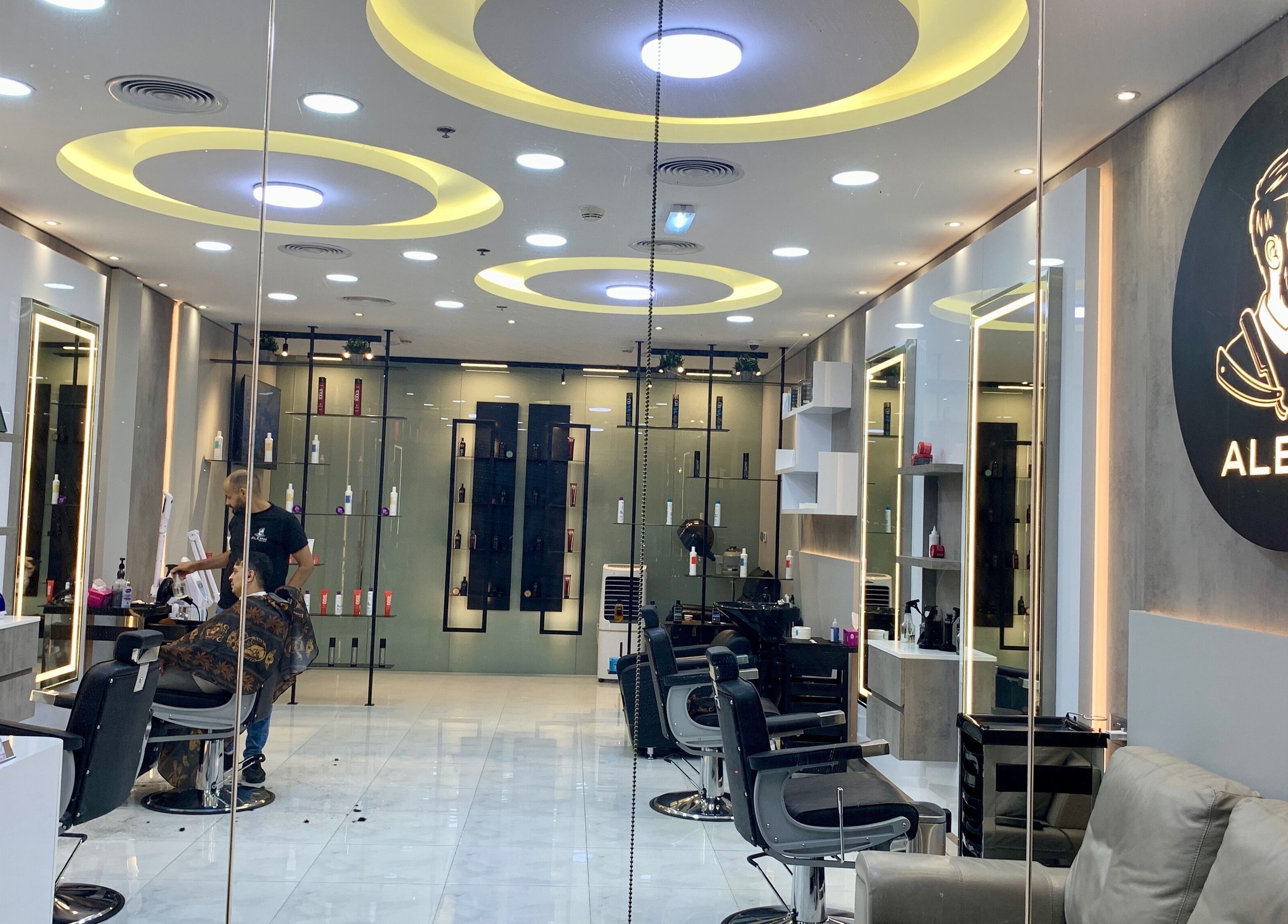 Interior of Aleph Gents Salon DMCC in Dubai, AE, showcasing sleek design and barber stations.