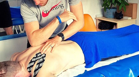 Massage therapy session at Thrive Kent in Maidstone, England, GB, focusing on back and shoulder relief.