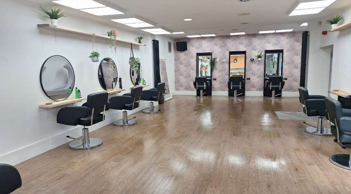 Bright, modern interior of El salon & jdaviesbridal in Carlisle, England, GB showcasing sleek styling stations.