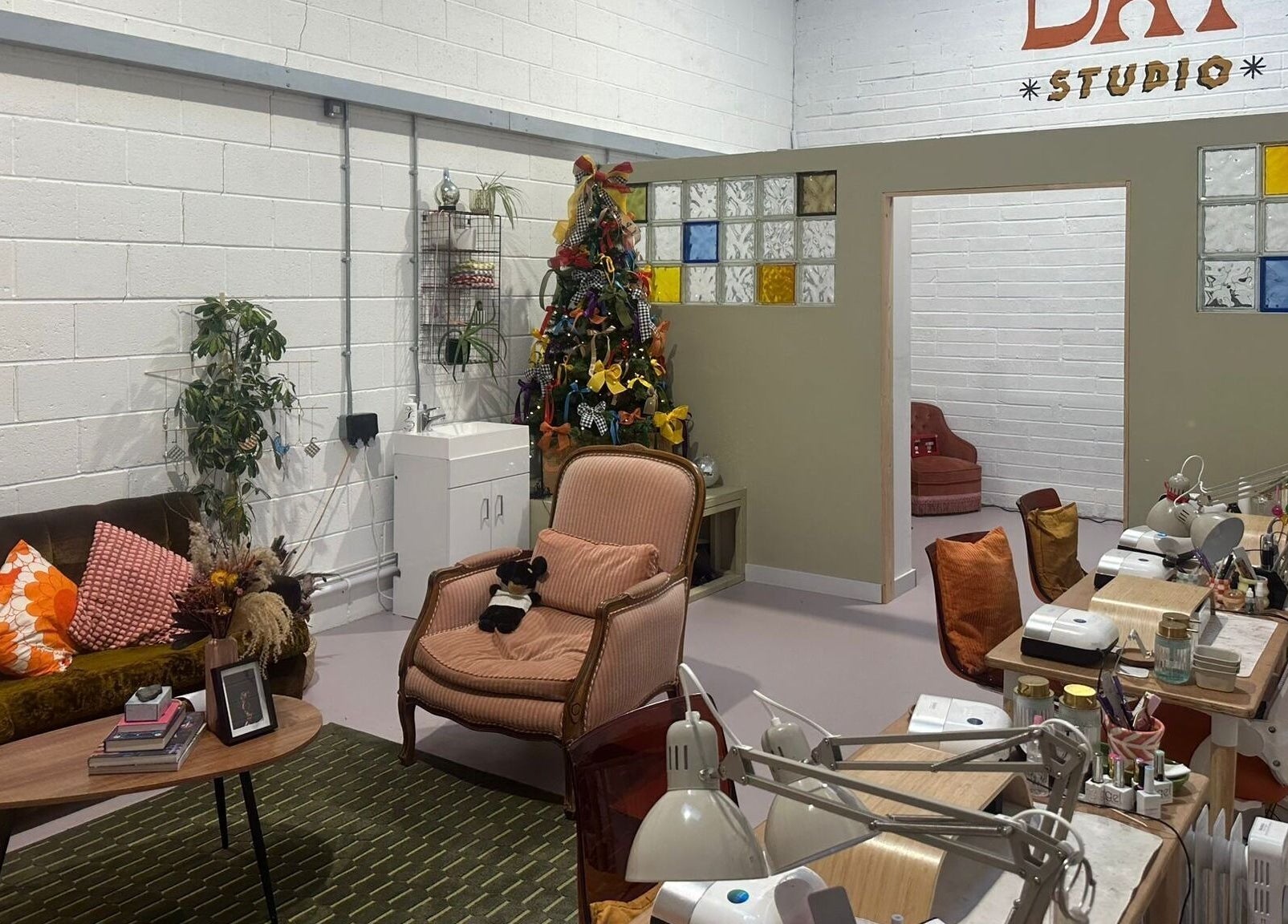 Welcoming lounge at Sun Day Studio, Truro, England, GB, featuring comfortable seating and vibrant decor.